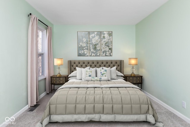 carpeted bedroom featuring baseboards