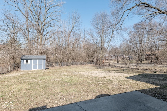 view of yard featuring a fenced backyard, a shed, and an outdoor structure