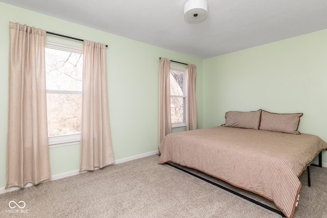 carpeted bedroom featuring baseboards