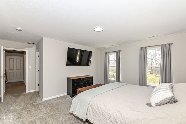 carpeted bedroom with visible vents and baseboards