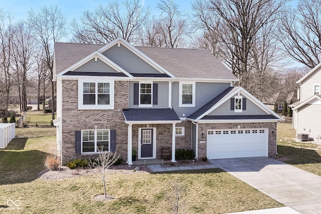 traditional-style house with an attached garage, driveway, a shingled roof, and a front lawn