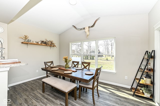 dining area with lofted ceiling, baseboards, and dark wood-style flooring