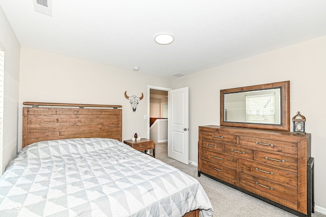 bedroom with visible vents, baseboards, and light colored carpet