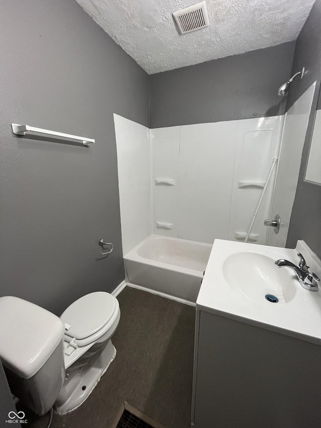 bathroom with visible vents, toilet, vanity, wood finished floors, and a textured ceiling