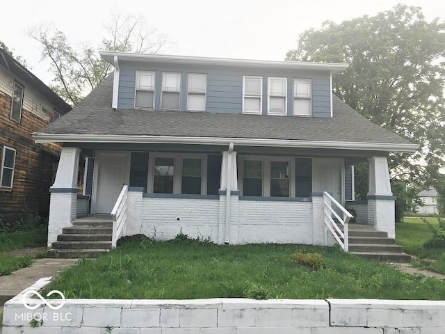 view of front of home featuring a porch and a shingled roof