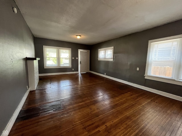 unfurnished room featuring baseboards and wood-type flooring