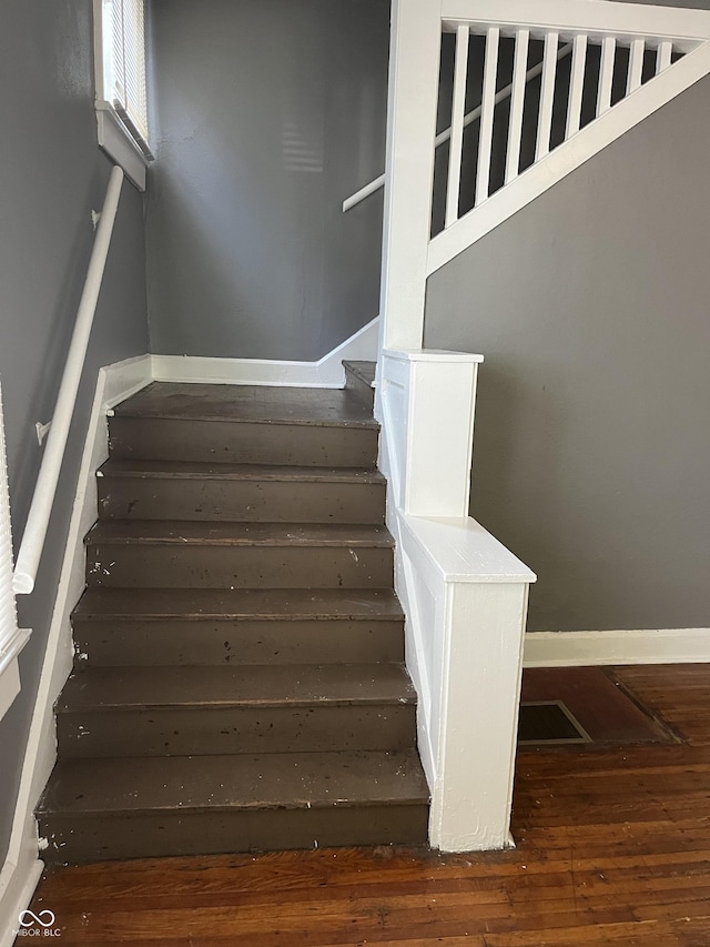 stairs with baseboards and hardwood / wood-style floors