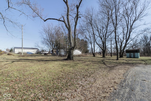 view of yard with aphalt driveway