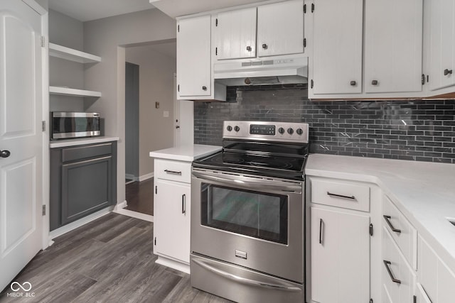 kitchen featuring under cabinet range hood, stainless steel appliances, light countertops, and open shelves