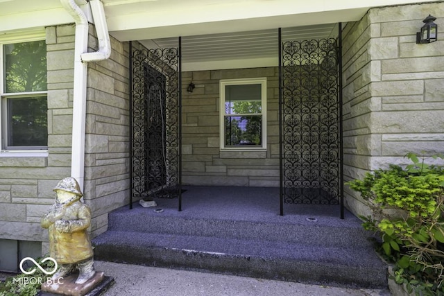 6204 S Madison Ave, Indianapolis, IN 46227 - property entrance with a porch and stone siding