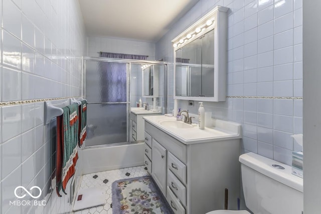 6204 S Madison Ave, Indianapolis, IN 46227 - full bath featuring tile walls, vanity, bath / shower combo with glass door, and tile patterned flooring