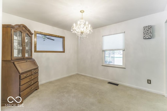 6204 S Madison Ave, Indianapolis, IN 46227 - spare room featuring light carpet, a chandelier, and a ceiling fan