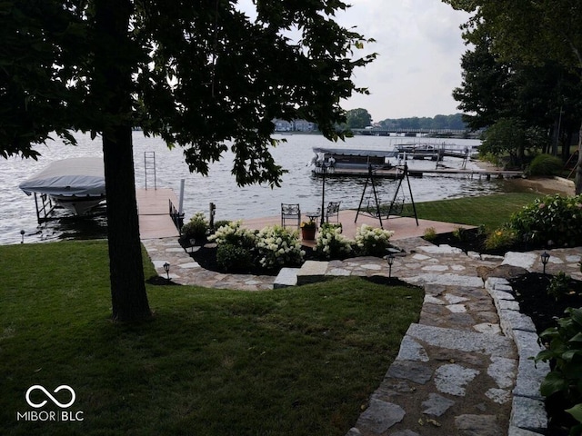 view of yard featuring a dock and a water view