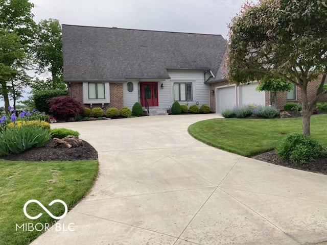 view of front facade featuring brick siding, concrete driveway, a front yard, roof with shingles, and an attached garage