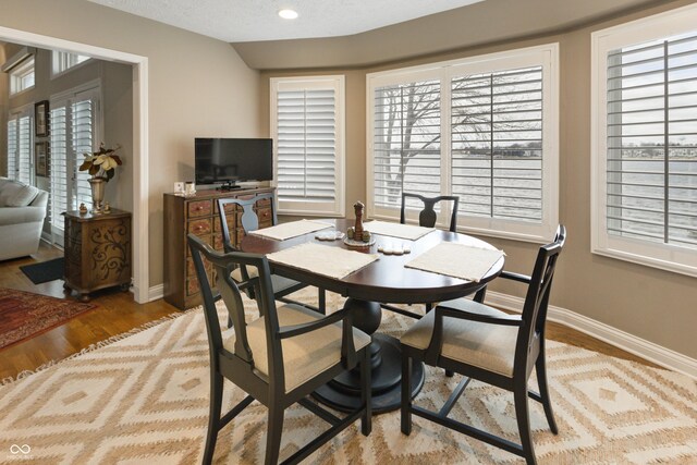 dining area featuring recessed lighting, a textured ceiling, baseboards, and wood finished floors