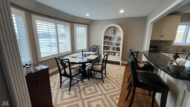 dining area with a toaster, recessed lighting, baseboards, and a textured ceiling