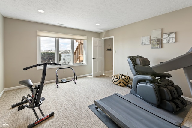 exercise area featuring carpet flooring, recessed lighting, a textured ceiling, and baseboards