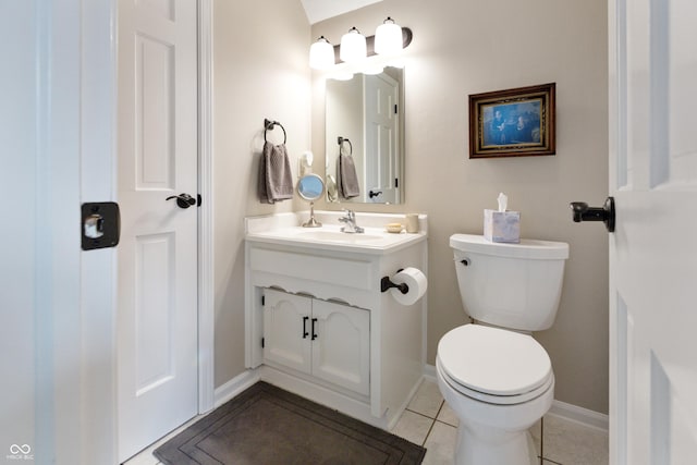 half bath featuring vanity, tile patterned floors, toilet, and baseboards