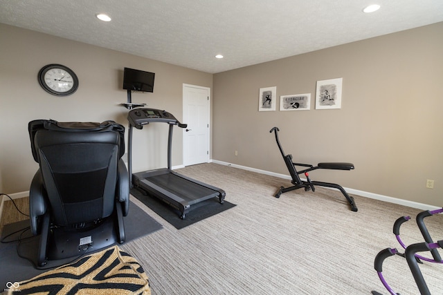 exercise area with carpet flooring, recessed lighting, a textured ceiling, and baseboards