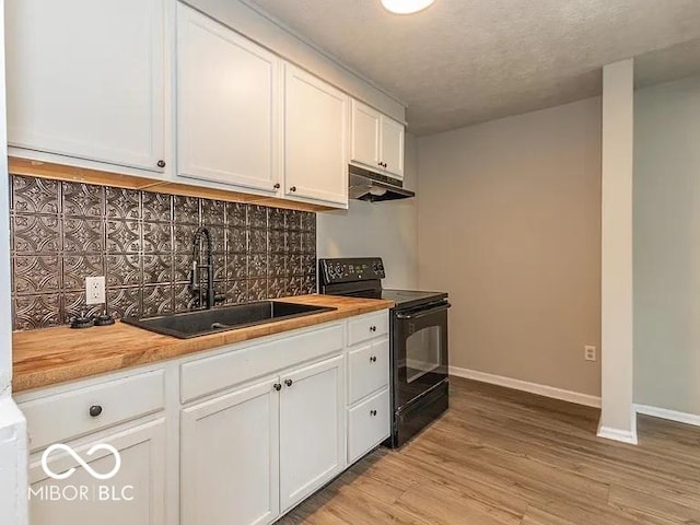 kitchen featuring light wood-type flooring, a sink, under cabinet range hood, black / electric stove, and wooden counters