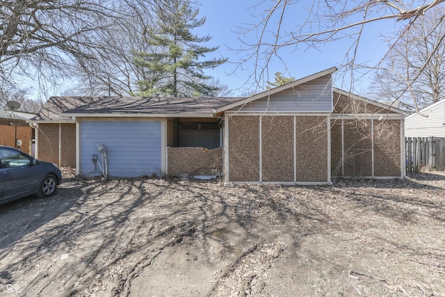 exterior space with an attached garage and fence