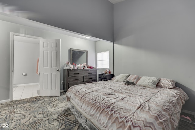 bedroom with tile patterned flooring and baseboards