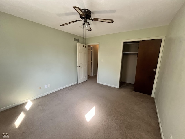 unfurnished bedroom featuring visible vents, carpet, baseboards, a closet, and a ceiling fan