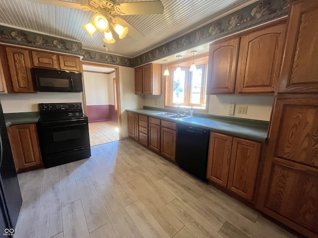 kitchen featuring brown cabinetry, ceiling fan, a sink, black appliances, and light wood-type flooring