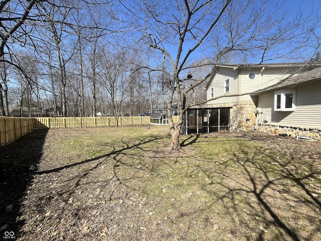 view of yard with fence private yard and a sunroom