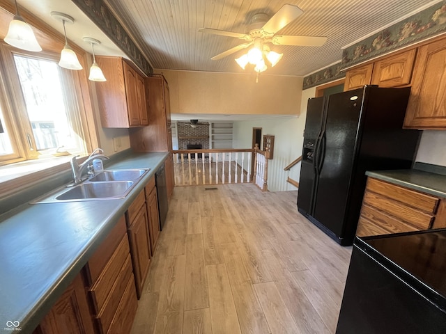 kitchen featuring brown cabinetry, light wood-style flooring, ceiling fan, a sink, and black refrigerator with ice dispenser