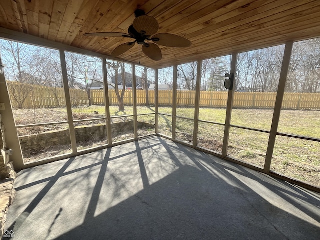 unfurnished sunroom with wooden ceiling and a ceiling fan