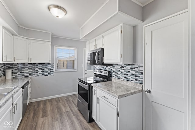 kitchen featuring backsplash, crown molding, appliances with stainless steel finishes, white cabinets, and dark wood-style flooring