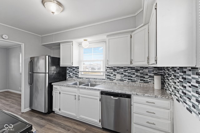 kitchen with a sink, stainless steel appliances, and white cabinetry