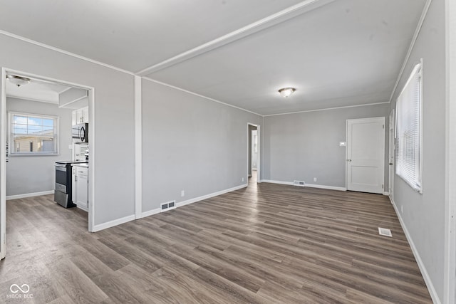 unfurnished room featuring visible vents, dark wood-style floors, baseboards, and ornamental molding