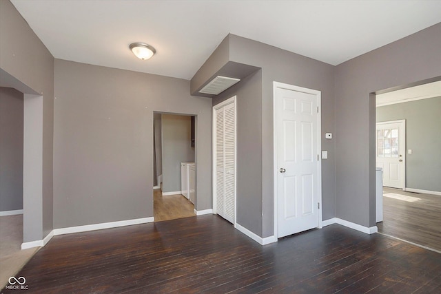 interior space featuring a closet, baseboards, and wood-type flooring