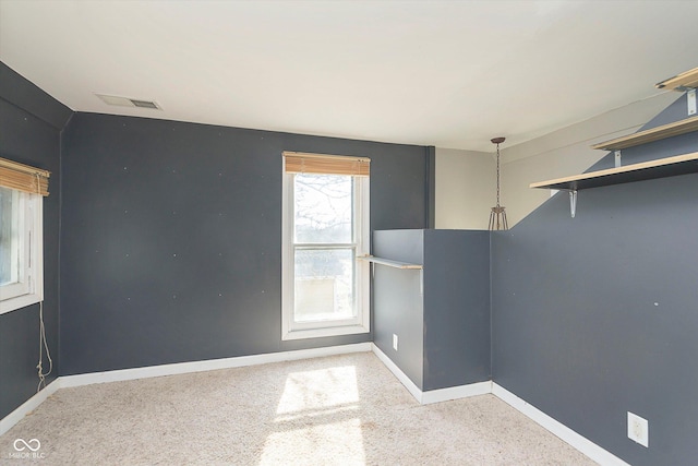 spare room featuring visible vents and baseboards