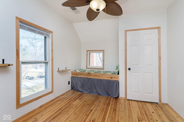 bathroom featuring visible vents, lofted ceiling, ceiling fan, and hardwood / wood-style floors