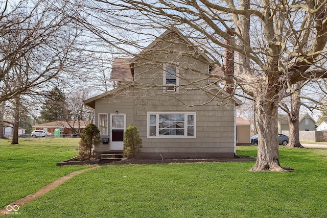 view of front of house featuring entry steps and a front lawn