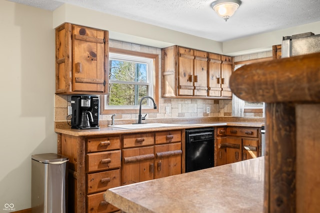 kitchen with light countertops, black dishwasher, brown cabinets, and a sink