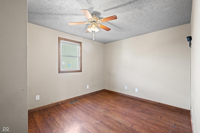 empty room with a textured ceiling, baseboards, ceiling fan, and hardwood / wood-style flooring