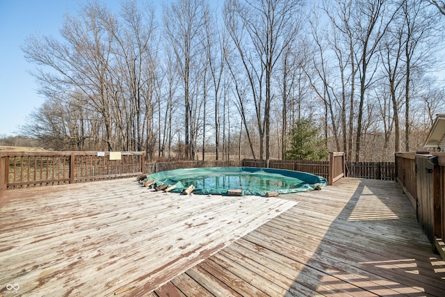 view of swimming pool with a fenced in pool and a wooden deck