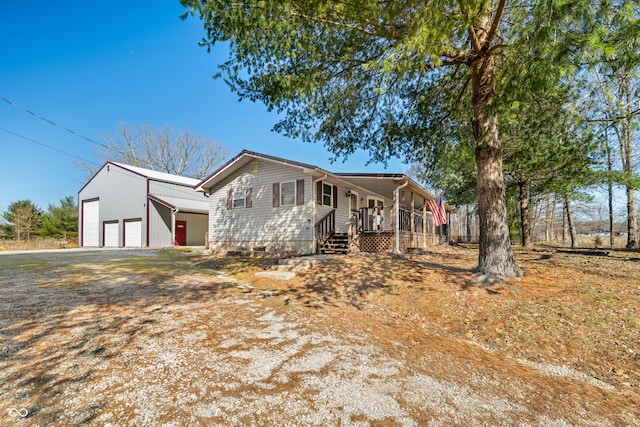 view of front of home with a garage, an outbuilding, and covered porch