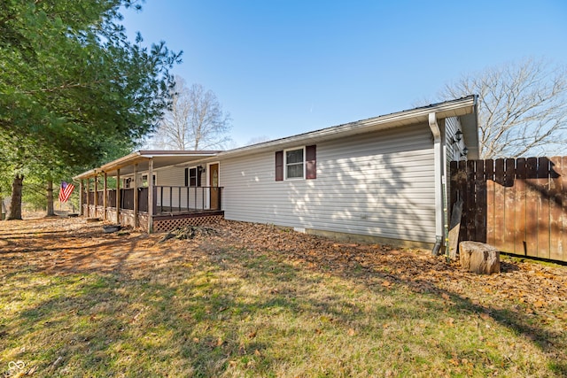 back of property with a deck and fence