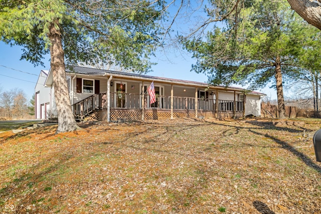 ranch-style house with metal roof and covered porch