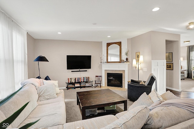 carpeted living room with recessed lighting, plenty of natural light, and a tile fireplace