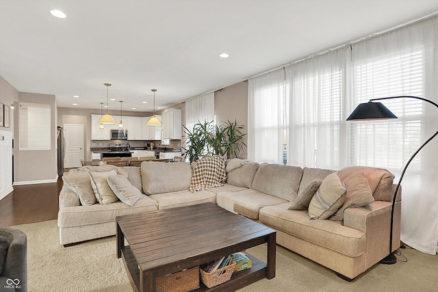 living room with recessed lighting and light wood-style flooring