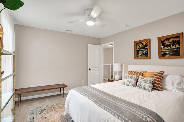 bedroom with ceiling fan, baseboards, visible vents, and light carpet