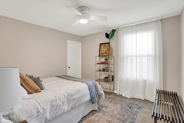 carpeted bedroom with a ceiling fan