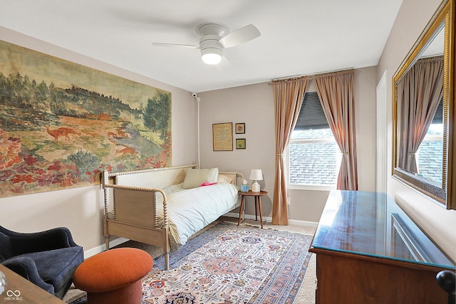 carpeted bedroom featuring baseboards and a ceiling fan