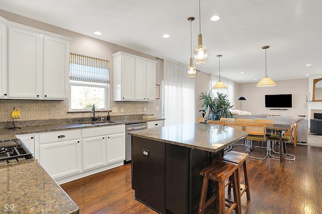 kitchen featuring a sink, dark wood-type flooring, open floor plan, white cabinets, and stainless steel dishwasher